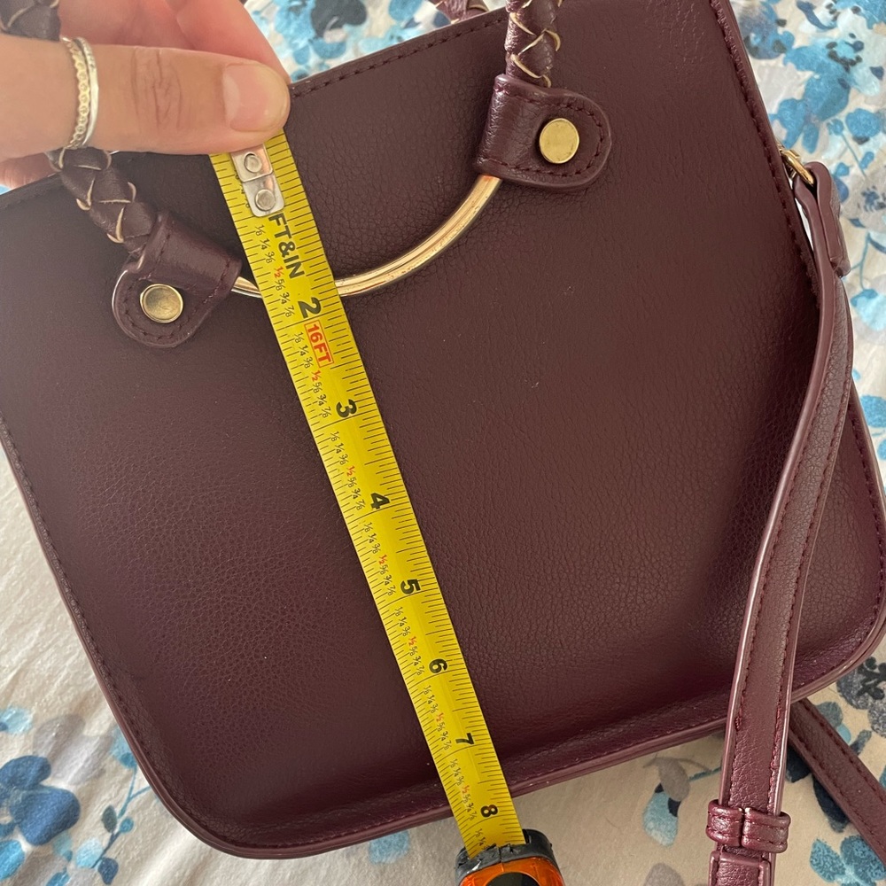 Madison West burgundy top handle crossbody bag.